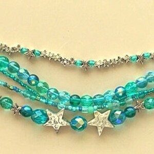 May include: Multi-strand bracelet with turquoise and silver beads, featuring star-shaped charms.