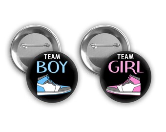 Team Boy and Team Girl Sneaker gender reveal pins.  Black background with gray, pink and blue.