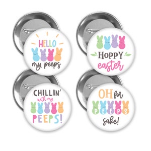 May include: Four round button pins with Easter-themed designs featuring colorful marshmallow Peeps. The pins say "Hello my peeps", "Hoppy Easter", "Chillin' with my peeps", and "Oh for Peeps sake!"