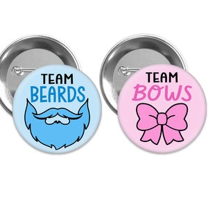 May include: Two round button pins with a gender reveal theme. The blue pin says "Team Beards" with a cartoon blue beard. The pink pin says "Team Bows" with a cartoon pink bow.
