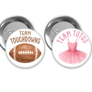 May include: Two round pinback buttons. One features a watercolor football with the text "TEAM TOUCHDOWNS" in brown. The other button has a pink tutu and the text "TEAM TUTUS" in pink. Both buttons have a silver metal backing.