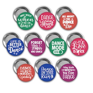 May include: Ten round button pins with various dance-themed sayings. The pins are in different colors, including red, green, blue, pink, and purple. The sayings include "Dance Your Heart Out", "Life is Better When You Dance", "Dance Mode On", "Live Love Dance", and "Why Walk When You Can Dance".
