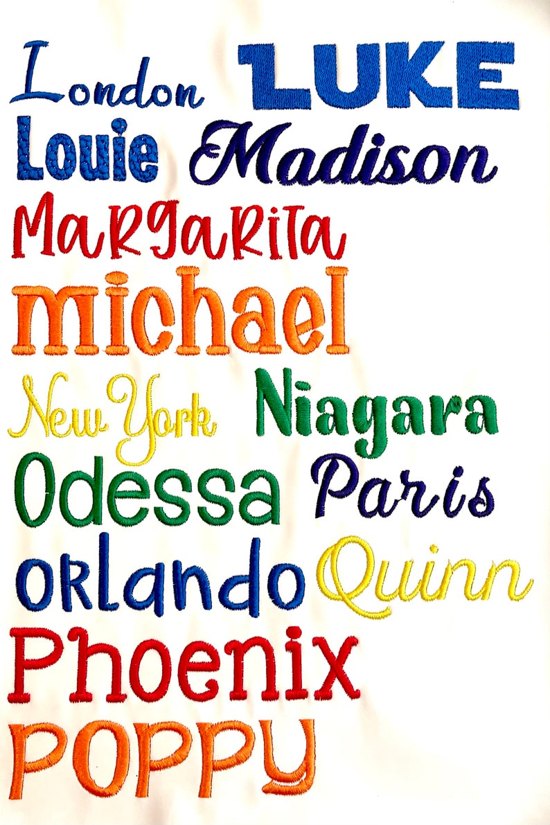 Pode incluir: Um fundo branco com um arco-&iacute;ris de nomes bordados, incluindo Londres, LUKE, Louie, Madison, Margarita, michael, Nova Iorque, Ni&aacute;gara, Odessa, Paris, Orlando, Quinn, Phoenix e POPPY.