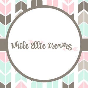 May include: A white circle with the text "while Ellie Dreams" in brown cursive lettering. The circle is surrounded by a brown and pink chevron pattern.