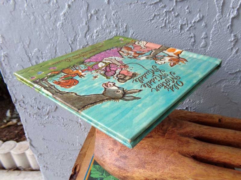 May include: A vintage children's book titled "Old MacDonald Had a Farm" with colorful illustrations of animals on a blue and green background.