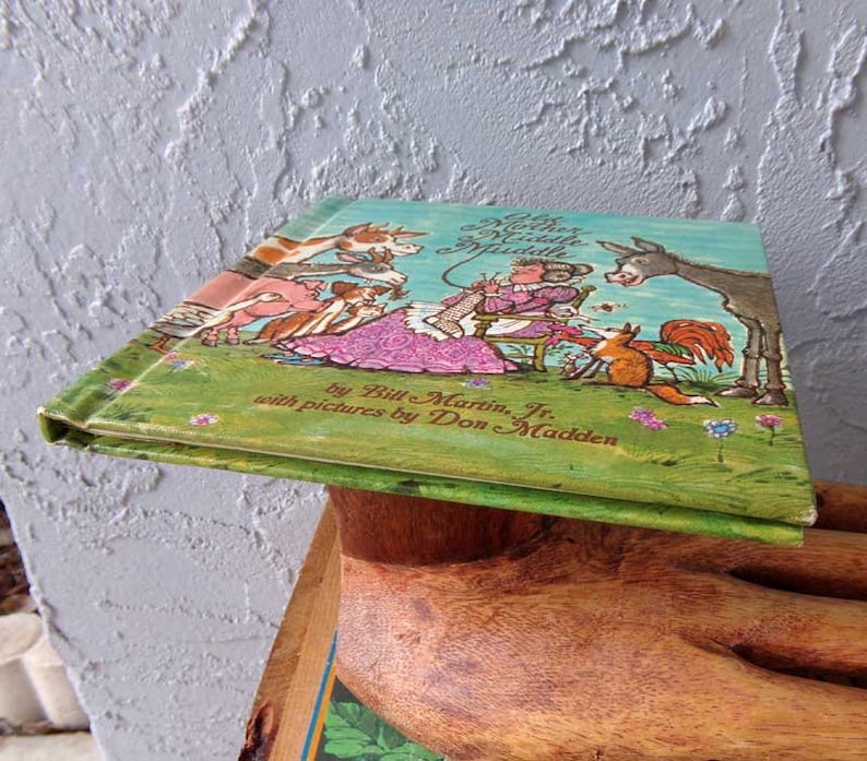 May include: A vintage children's book titled "The Mother Who Didn't Know Much" by Bill Martin Jr. with pictures by Don Madden. The cover features a colorful illustration of a mother and her animal friends.
