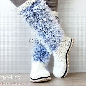 May include: White and blue crochet boot with a fluffy white trim. The boot has a black trim around the sole. The boot is on a wooden surface. Crochet pattern by AdrianaM.