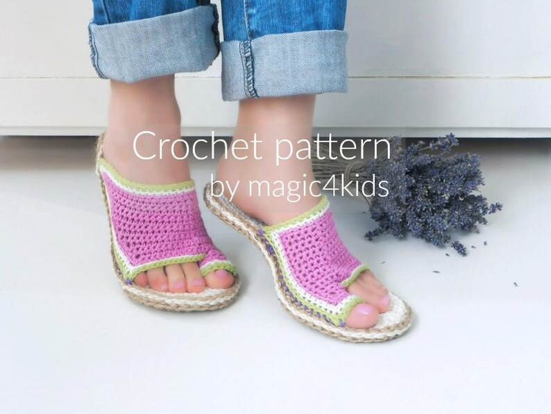 May include: A pair of pink and green crocheted sandals with a woven sole. The sandals are being worn by a person with their feet crossed.