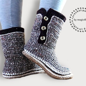 May include: Crocheted brown and grey slipper boots with white trim and brown buttons. The boots have a crocheted sole.