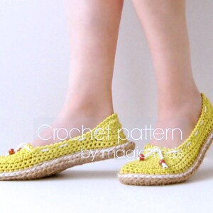May include: Crocheted yellow flats with a jute sole and white stitching. The shoes have brown beads on the laces. "Crochet pattern by magic stitches" is written on the image.