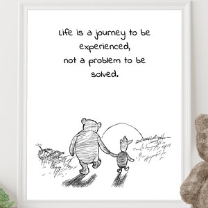 May include: Black and white illustration of Winnie the Pooh and Piglet walking in a forest. The quote "Life is a journey to be experienced, not a problem to be solved." is printed above the illustration.