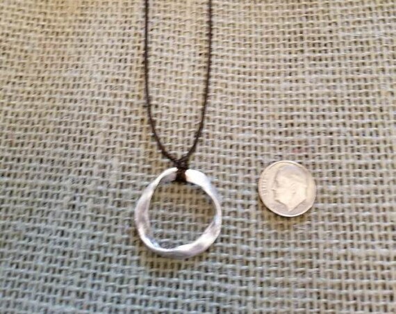 Necklace with a Silver Tone Ring Pendant