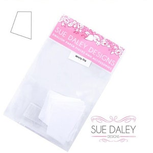 May include: A white plastic bag with a pink label that says "Sue Daley Designs English Paper Pieces and Accessories" and "Whirly Gig". The bag contains white paper pieces for crafting.