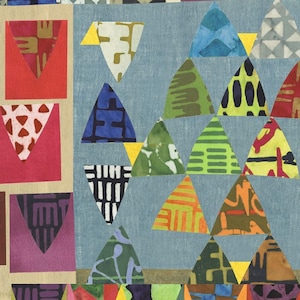 May include: A colorful abstract art piece made of fabric scraps. The artwork features a variety of geometric shapes, including triangles, squares, and rectangles. The colors are bright and vibrant, and the overall effect is playful and whimsical.