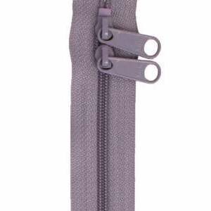 May include: A gray zipper with two metal sliders. The zipper is closed and ready to be sewn into a garment.