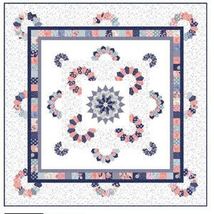 May include: A white quilt with a central square design, bordered by a navy blue frame. The quilt features a repeating pattern of floral and geometric shapes in shades of pink, blue, and white. The background has a speckled pattern.