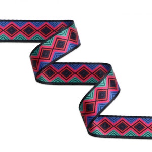 May include: A colorful ribbon with a geometric pattern in shades of blue, red, green, and black. The ribbon is woven with a diamond pattern.