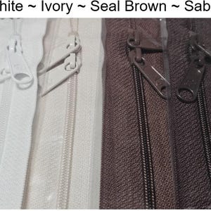 May include: Four zipper tapes in different colors: white, ivory, seal brown, and sable. The zippers are all closed and the slider is visible.