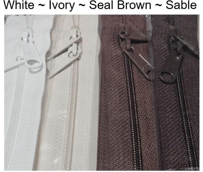 May include: Four zipper tapes in different colors: white, ivory, seal brown, and sable. The zippers are all closed and the slider is visible.