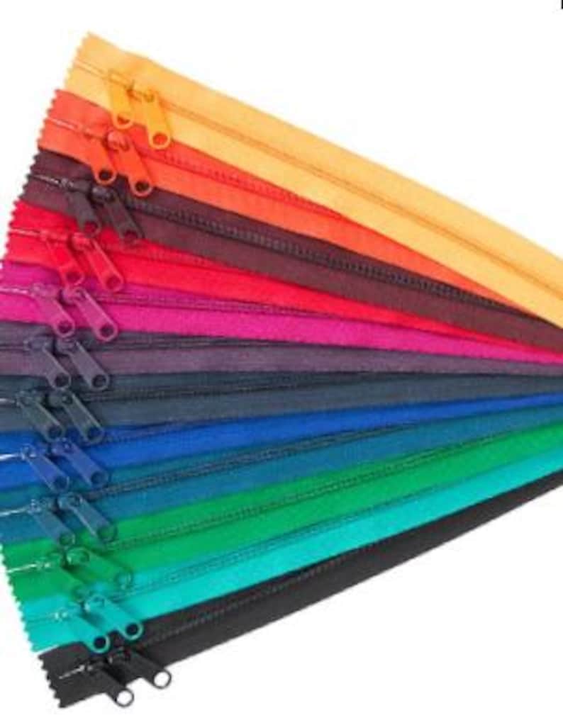 May include: A collection of colorful zipper tapes in various shades of red, orange, yellow, green, blue, and black. The zippers are arranged in a fan shape, with the top zipper being yellow and the bottom zipper being black.