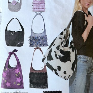 May include: A Simplicity 4117 sewing pattern envelope featuring illustrations of six different shoulder bag designs. Styles include a cow print hobo bag, a purple bag with floral embroidery, a black bag with fringe, and other variations with sequins or studs.