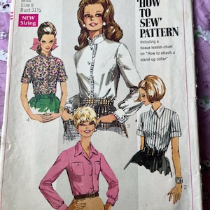May include: Vintage Simplicity sewing pattern 7780. The pattern features illustrations of women's blouses with various styles, including a pink button-up shirt, a floral print top, and a white blouse with a stand-up collar. The pattern includes a tissue lesson-chart.