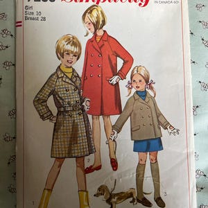 May include: Vintage Simplicity sewing pattern envelope featuring illustrations of girls in coats. The envelope is labeled "7259" and includes the text "Girl Size 10 Breast 28". The price is listed as 50¢.