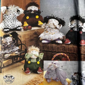 May include: Simplicity crafts pattern 5015 featuring various handmade rag dolls. The dolls have different outfits and hairstyles, with some wearing overalls, dresses, and polka dots. The pattern includes instructions for creating these whimsical fabric dolls.