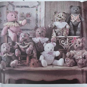May include: A collection of handmade teddy bears in various fabrics and styles, including floral, gingham, and solid colors. Some bears have frilly collars and bows. The image is from a craft pattern.