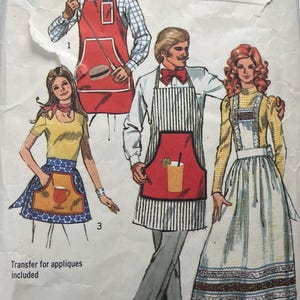 May include: Vintage Simplicity sewing pattern 6097 featuring apron designs. The illustration shows four different apron styles, including a red apron with a pocket and a striped apron. The text "ONE SIZE" is visible.