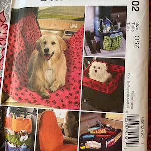 May include: A McCall's Crafts M5902 sewing pattern envelope for vehicle accessories. The front displays images of a red paw-print pet seat cover, a car seat organizer, a console storage bin, a seat back organizer, and a solid orange seat cover.