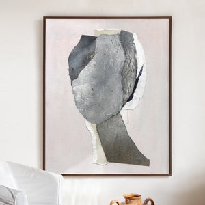 May include: Abstract art print featuring a grey and white collage of shapes on a light pink background. The artwork is framed in a dark brown frame.