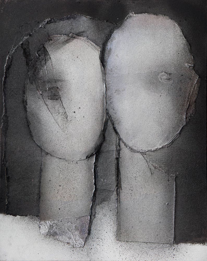 A modern art print of a noir abstract portrait of a grayscale love couple on spray-painted black-and-white background. The heads are from torn paper layers with exposed grungy edges and two roughly outlined eyes. The texture is rough and grainy.