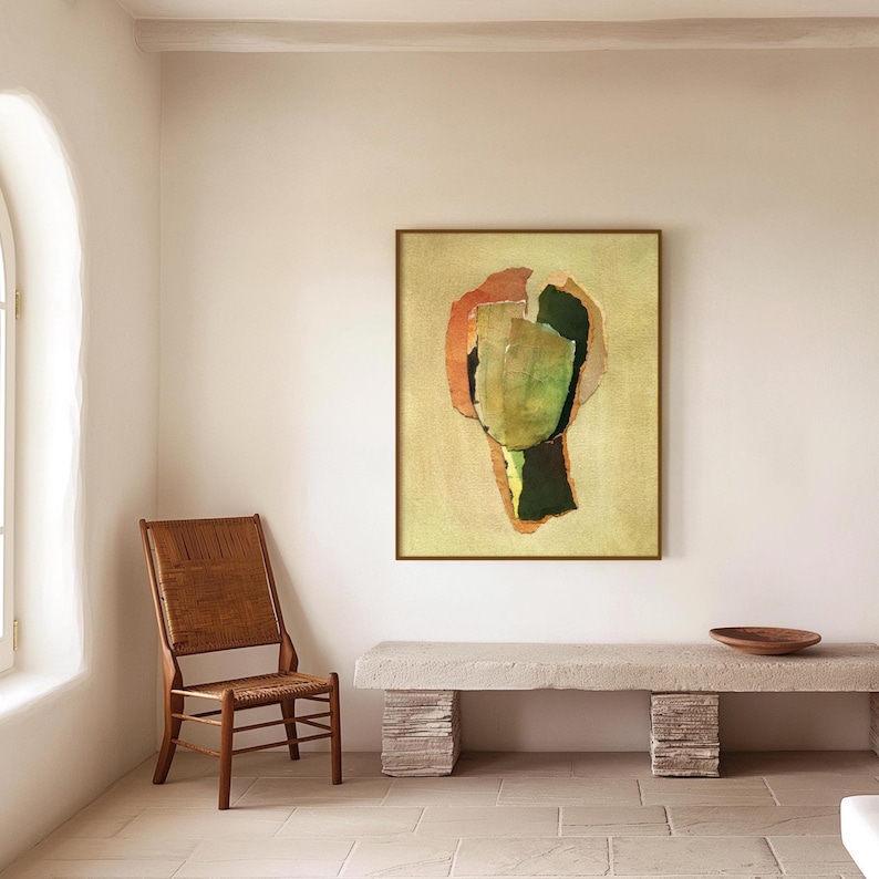 May include: Abstract art piece in a gold frame. The artwork features a central green shape with orange and black accents on a beige background. A wooden chair and stone bench are in the room.