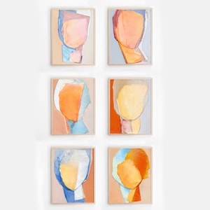 May include: Six abstract paintings in a grid pattern, each featuring a colorful, layered, and textured portrait of a face. The paintings are framed in light wood and have a white background.