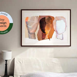 A 2023 Etsy Design Award finalist original art print on a wall in a white bedroom. The tree abstract heads are in grayish to brown orange, in intense dark wood to pale pinky orange and marble white with violet. Modern artwork in dark brown frame.