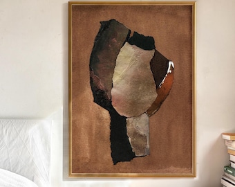 May include: Abstract art print in a gold frame. The artwork features a collage of shapes in shades of brown, black, and beige against a brown background. The framed art is displayed on a wooden nightstand next to a bed.