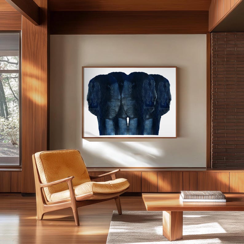 Puede incluir: Una pintura abstracta azul de tres caras, enmarcada y colgada en una pared blanca en una sala de estar moderna con suelo de madera y un sill&oacute;n de cuero marr&oacute;n.