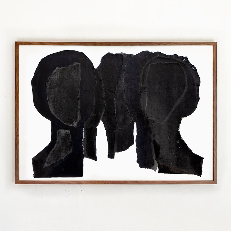 A wall decor with a large statement art in shades of brushed eerie black and dovetail grey. This chestnut framed group portrait has five abstract heads. The overlapping layers of torn paper, finished in opaque shades of black are arranged in an arch.