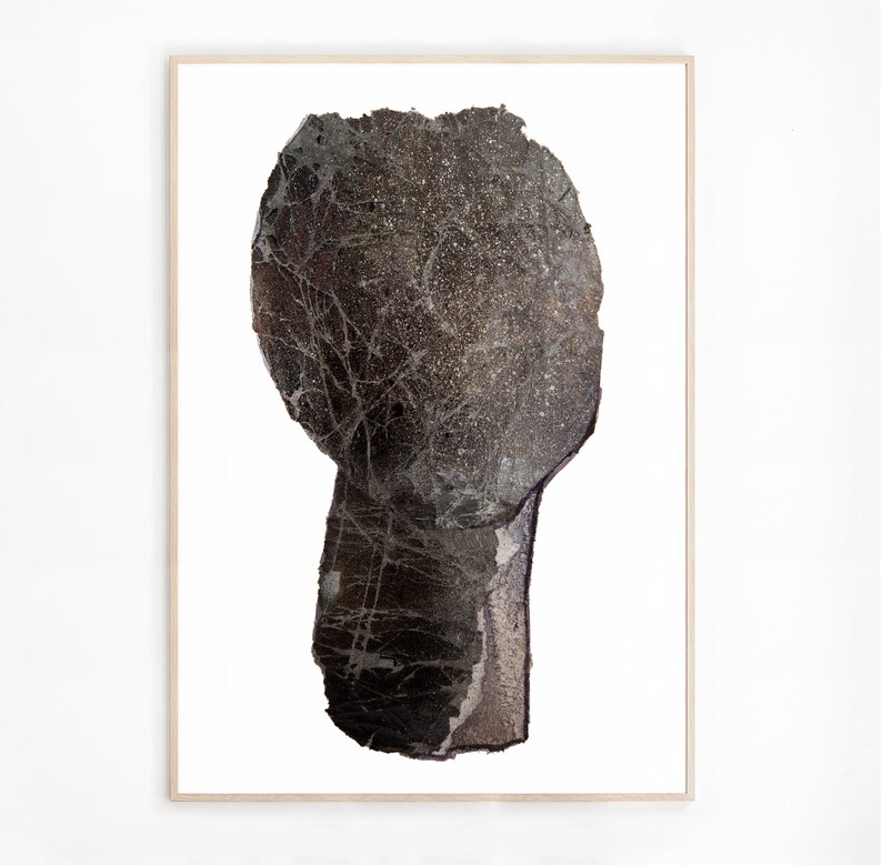 A modern high quality art print of an abstract head in shades of graphite grey with silver spray painted accents. The torn paper layers have rocky texture, webbed with light grey and white to create light and rough torn edges, outlined with charcoal.