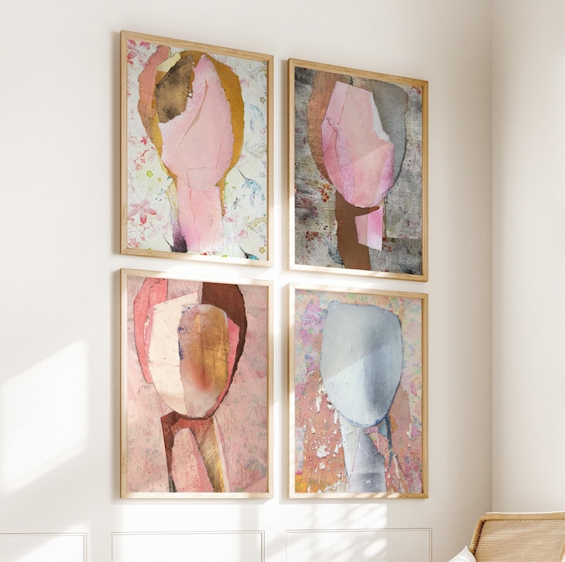 May include: Set of four abstract art prints featuring pink, brown, and blue abstract shapes on a white background. The prints are framed in natural wood.
