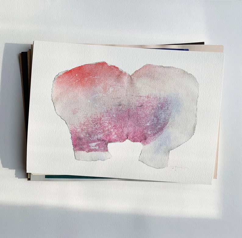 A high quality art print of a romantic abstract portrait of a kiss in off white, coral and lavender blush pink and pastel violet on white. It's composed of one piece torn paper with rough edges, accented with fine spray-painted bluish mist.
