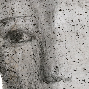 A detail of high quality art print of a modern abstract portrait in shades of gray.  The facial features are graphite sketched and have black paint drops accents. The texture is of an eraser brushed paper and thick paper.