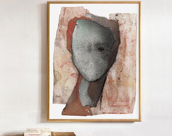 May include: A framed abstract art print featuring a central, textured gray oval shape resembling a head, set against a layered background of muted terracotta, beige, and cream tones with distressed paper-like edges and subtle dark speckling.