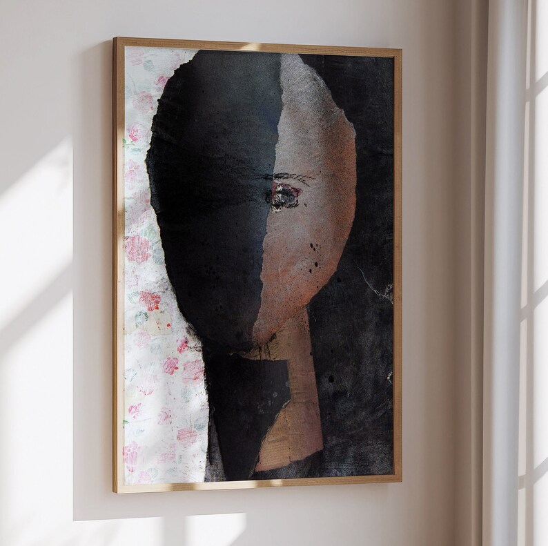 May include: Abstract painting of a face with a black and brown color scheme. The face is partially obscured by a black background. The painting is framed in a wooden frame.