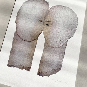 A high quality art print of a romantic abstract portrait of a love couple in shades of grey with silver finish on white. The two heads are composed of torn rough paper layers with exposed grungy edges and two eyes for accent.