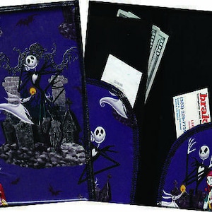 May include: A purple fabric wallet with a black fabric insert. The wallet features a printed design of characters from the Nightmare Before Christmas movie. The front of the wallet has a scene of Jack Skellington and Sally. The back of the wallet has a scene of Jack Skellington and Zero.