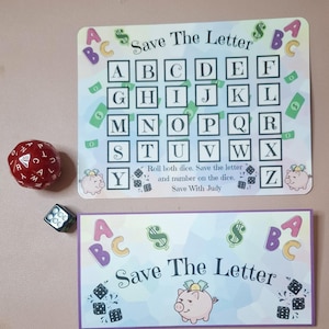 May include: A Save The Letter game set featuring a rectangular board with the alphabet in boxes, a smaller rectangular card, a red multi-sided die with letters, and a small black six-sided die. The board includes the text Save The Letter.