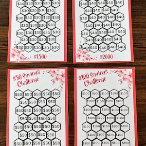 May include: Four red and white cards with a floral design and a savings challenge theme. Each card has a different savings amount: $30, $40, $50, and $100. The cards are arranged in two rows of two. The cards have a honeycomb design with the savings amount written in each cell. The total savings amount for each card is listed at the bottom. The cards read: '$30 Savings Challenge', '$40 Savings Challenge', '$50 Savings Challenge', and '$100 Savings Challenge'. The total savings amounts are: $1500, $2000, $2500, and $5000.