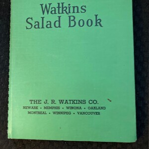 May include: A green book titled "Watkins Salad Book" with the publisher's information: "THE J. R. WATKINS CO. NEWARK MEMPHIS WINONA OAKLAND MONTREAL WINNIPEG VANCOUVER"